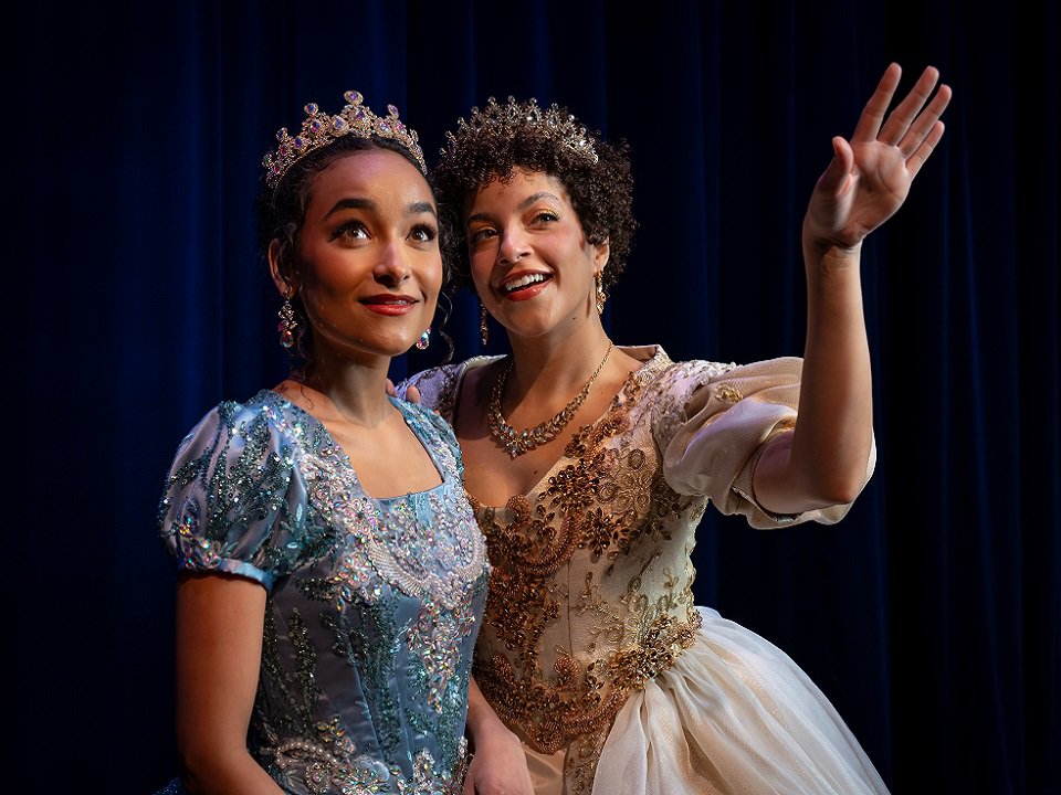 Two young women in ball gowns and tiaras.