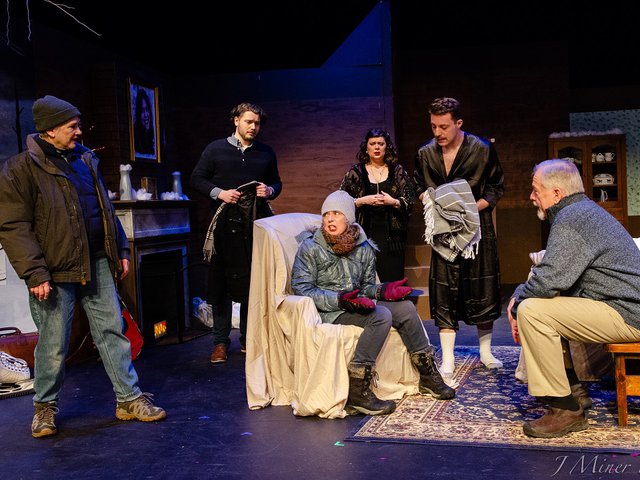 a group of people dressed for winter in a confrontational pose.